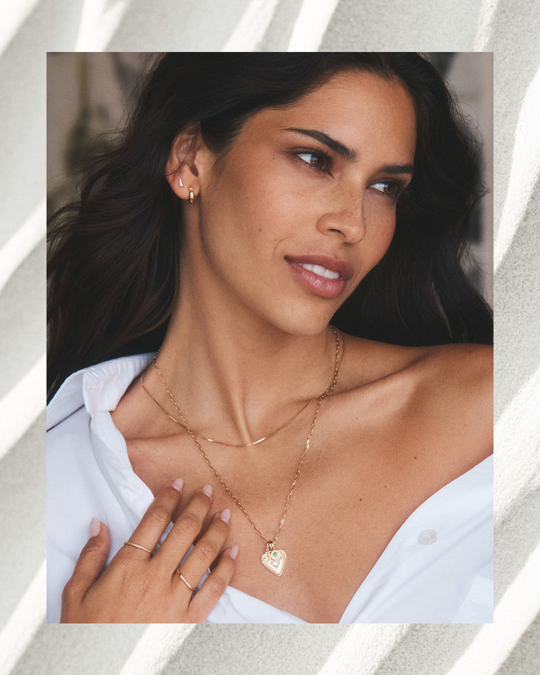 Model wearing 14k gold necklaces, charms, earrings and rings