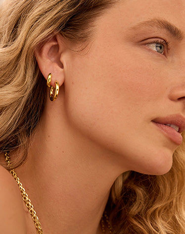 woman in two gold hoop earrings