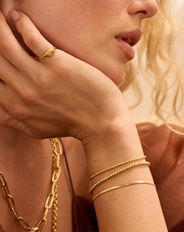 woman stacked in gold bracelets