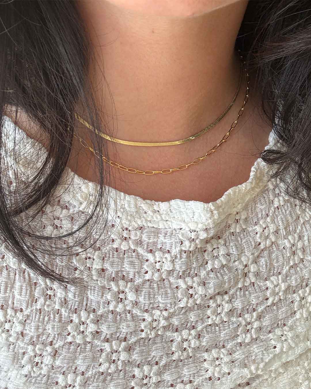 woman in gold necklaces