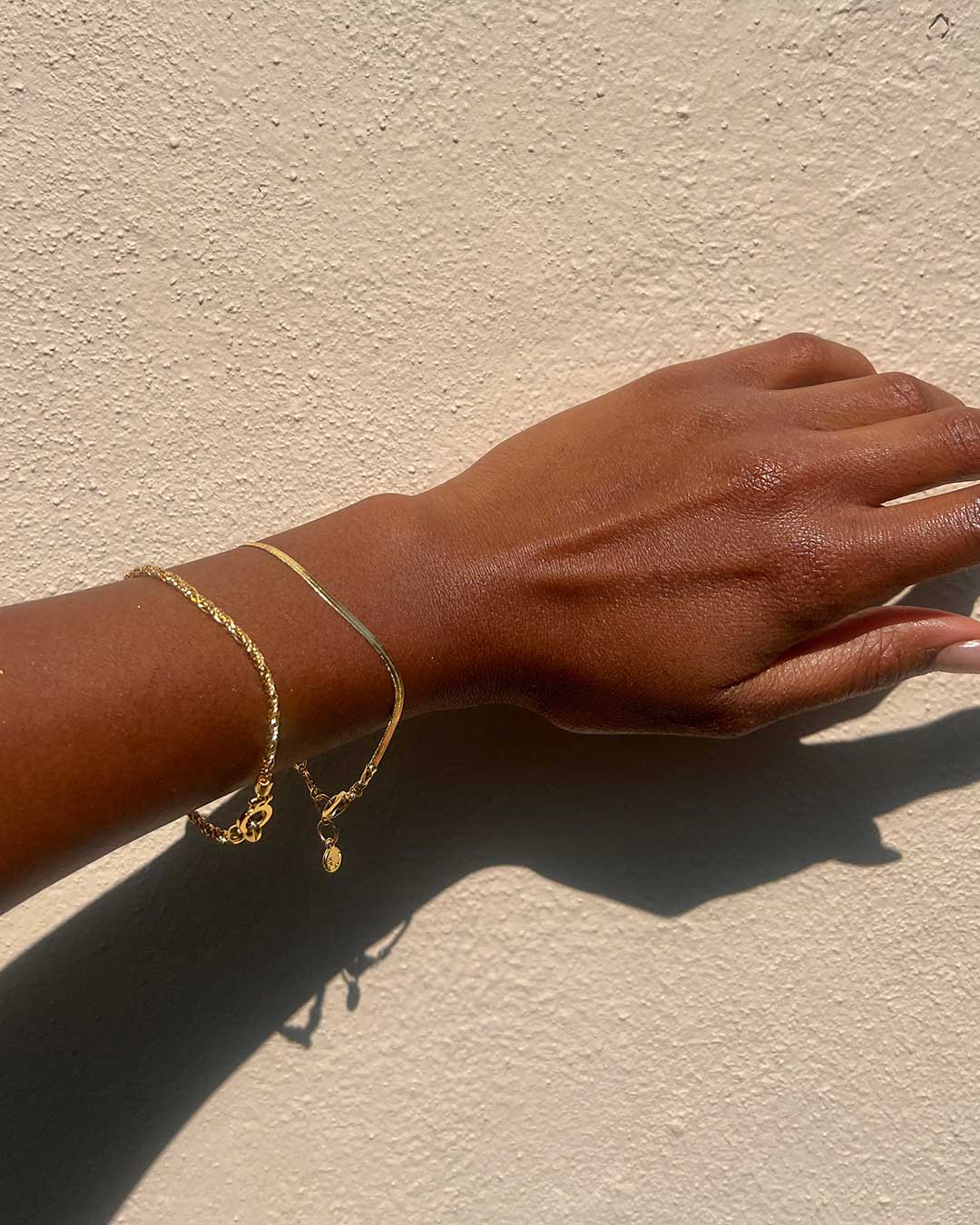 woman in gold bracelets